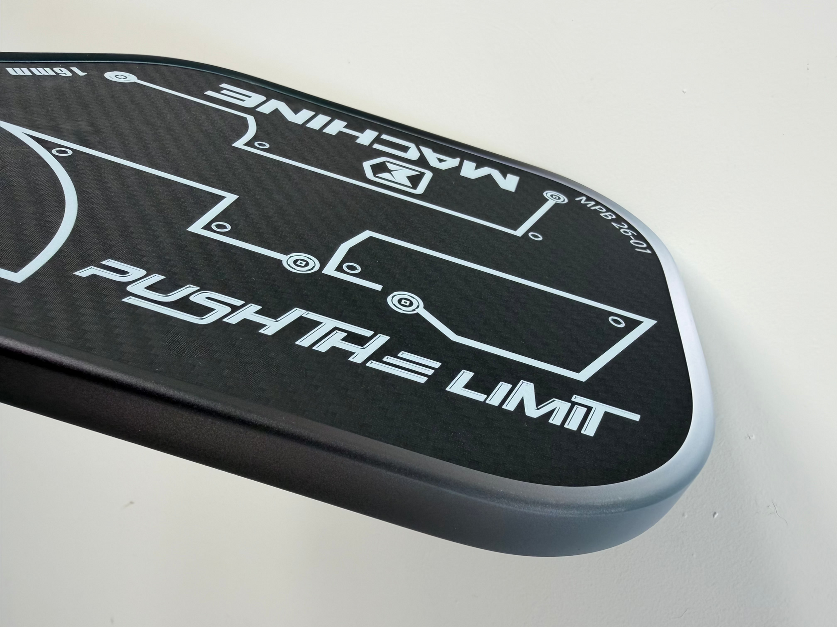 Close-up of a black and gray car spoiler with 'Machine' and 'Push the Limit' branding on a light gray background.